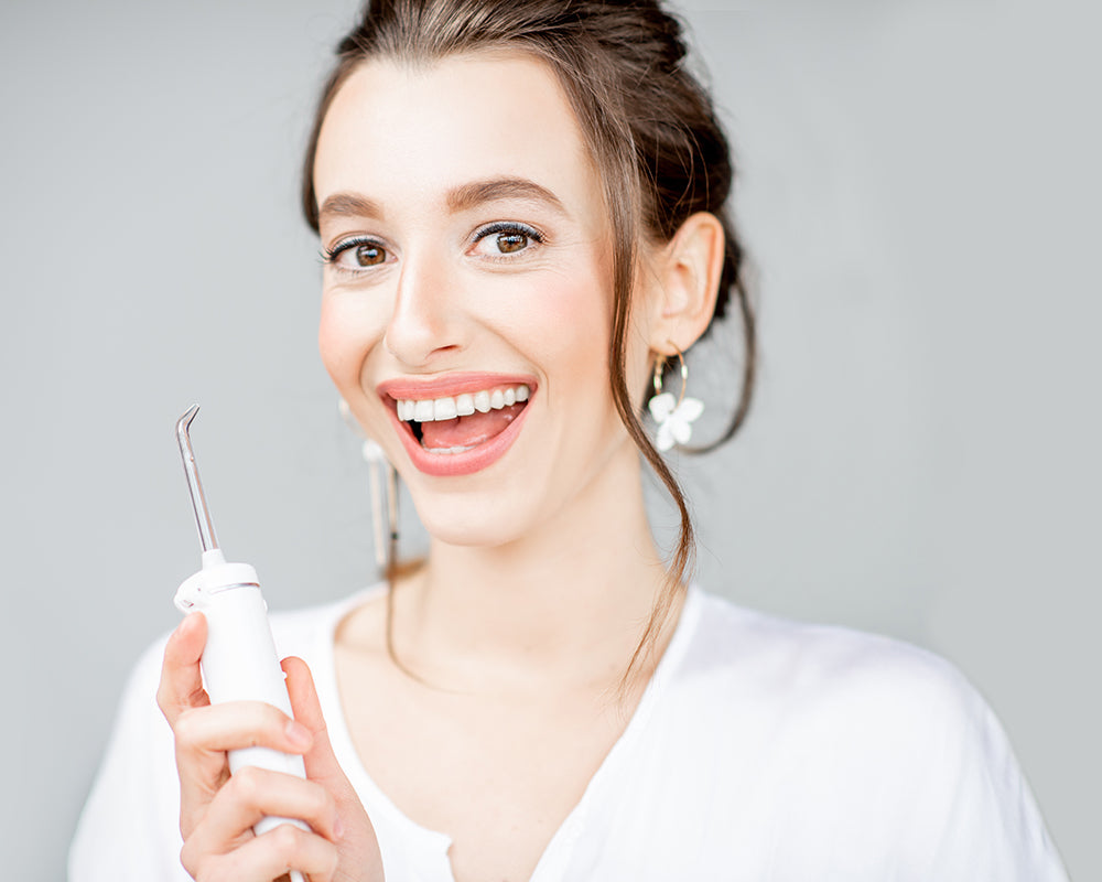 Portrait image of woman holding irrigator